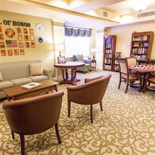 A cozy living room with comfortable seating and bookshelves.