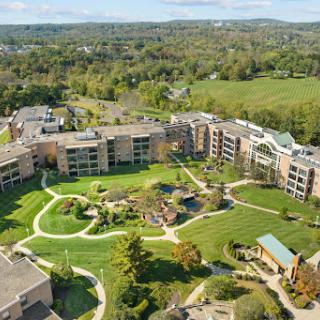 Aerial view of a well-designed residential complex surrounded by lush greenery.