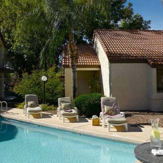 A sunny day at the resort with lounge chairs by the pool.