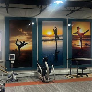 Inspiring gym decor featuring vibrant sunset silhouettes of yoga and dance.