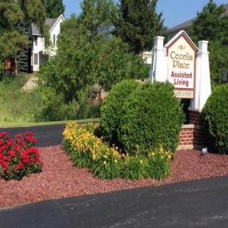 Entrance to an assisted living facility with vibrant flowers and well-maintained landscaping.