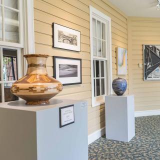 An art gallery showcasing pottery and artwork on display.