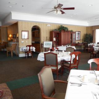 An elegant restaurant dining area with neatly arranged tables and chairs.