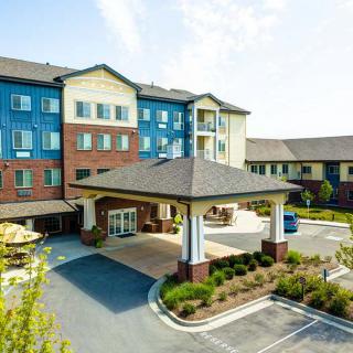 The exterior view of a modern hotel with a welcoming entrance and landscaped surroundings.