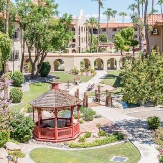 A beautifully landscaped garden with a gazebo and winding walkways.