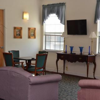 A cozy living room with comfortable seating, a television, and elegant decor.