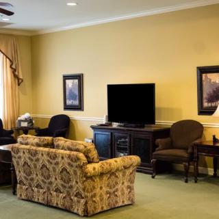 A cozy living room with comfortable seating, a television, and tasteful decor.