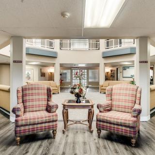 A cozy lobby area featuring two plaid armchairs and a small wooden table.
