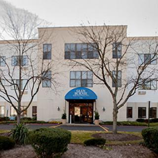 A modern office building featuring a welcoming entrance and landscaped surroundings.