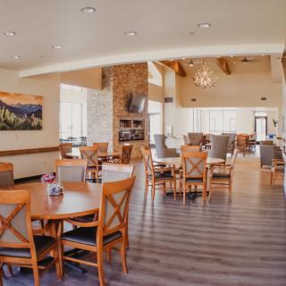 A spacious and elegantly decorated dining area with wooden tables and chairs.
