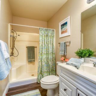 A neatly arranged bathroom with a shower, toilet, and sink.