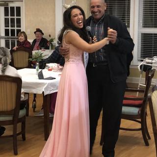 A joyful dance at a celebration with people in formal attire.