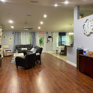 A spacious and modern living room featuring stylish furniture and warm lighting.