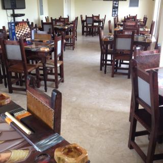 Empty restaurant interior with wooden tables and chairs.