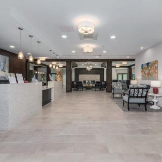 Modern lobby with elegant furnishings and ample lighting.