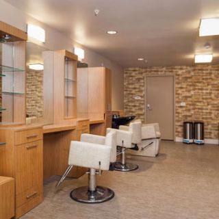 A modern hair salon interior with chairs and mirrors, featuring a stylish brick wall.