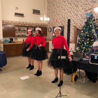 A festive dance performance with dancers in Christmas attire.