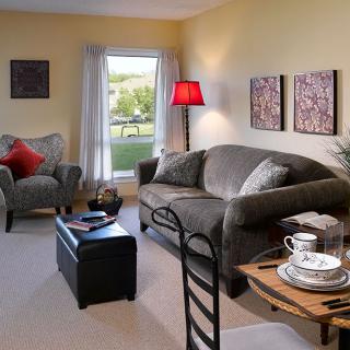 A cozy living room with comfortable seating, warm lighting, and stylish decor.
