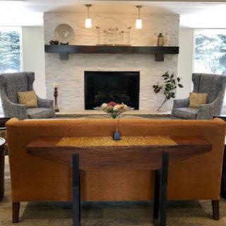A beautifully designed living room featuring a cozy seating area with a modern fireplace and elegant decor.