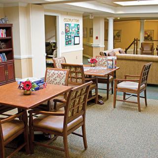 A communal dining area with neatly arranged tables and chairs.