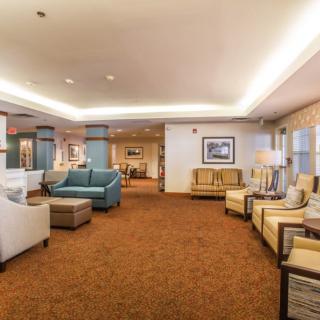 A spacious and elegantly designed hotel lobby with comfortable seating and warm lighting.