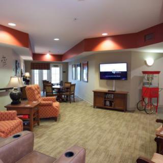 A cozy living room with comfortable seating, a wall-mounted television, and stylish decor.
