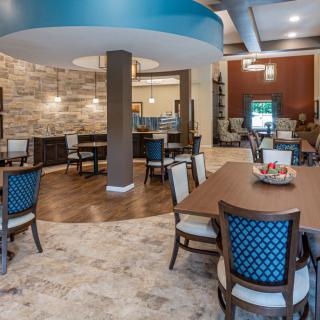 A stylishly decorated restaurant dining area with modern furniture and lighting.