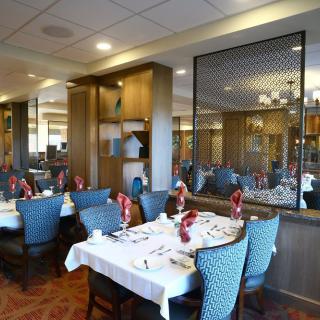 An elegant dining area with neatly set tables and cozy chairs in a restaurant.