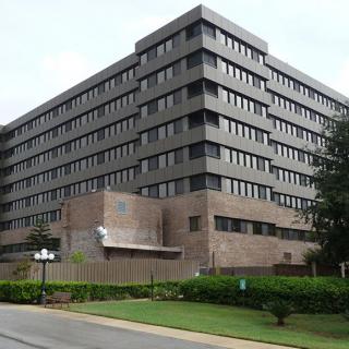A large multi-story hospital building surrounded by greenery.