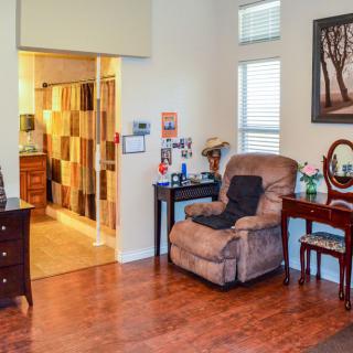 A cozy living room with a recliner chair and warm lighting.