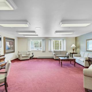 A spacious living room with comfortable seating and large windows.