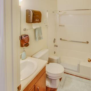 A compact bathroom featuring a sink, toilet, and bathtub with shower.