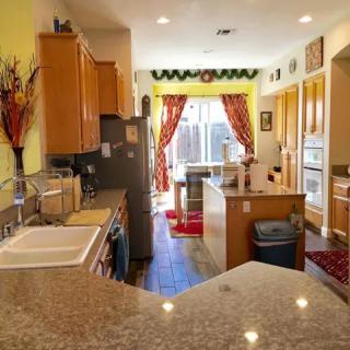 A spacious kitchen with modern appliances, featuring an island and ample countertop space.