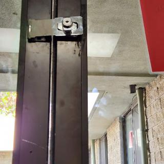A close-up view of a metal door lock on an entrance door.