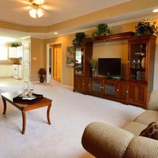 A cozy living room featuring a comfortable sofa, wooden TV stand, and stylish coffee table.