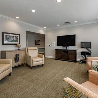 A cozy living room with comfortable seating and a large television.