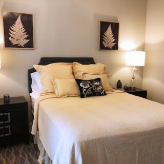 A cozy and inviting bedroom with soft bedding and tasteful decor.