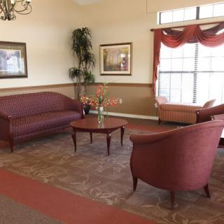 A cozy lobby area with elegant furniture and warm lighting.