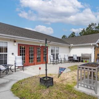 A spacious outdoor patio with seating and a clear sky above.