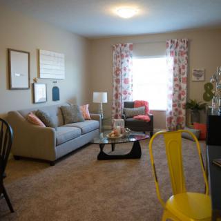 Cozy living room with modern decor and bright accents.