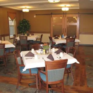 An elegant restaurant dining area with neatly arranged tables and chairs.