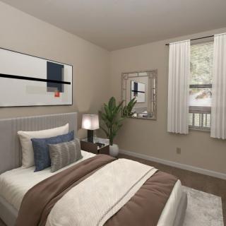 A modern bedroom with stylish decor, featuring a bed with pillows and a throw blanket, artwork on the wall, a mirror, a plant, and a window with curtains.