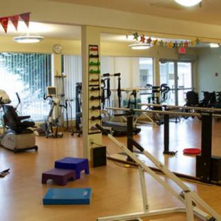 A gym interior featuring various exercise equipment and workout spaces.