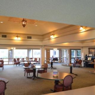 Spacious dining area with several tables and ample lighting.