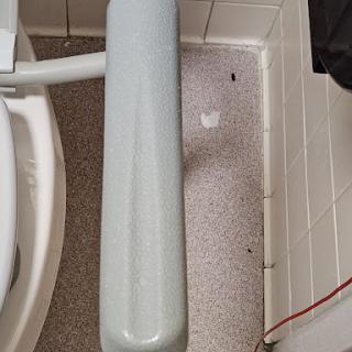 A view of a toilet with a grab bar installed, highlighting the area around it.