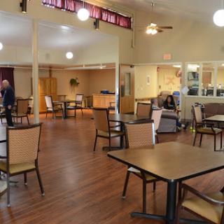 A spacious dining area with tables and chairs arranged for guests.