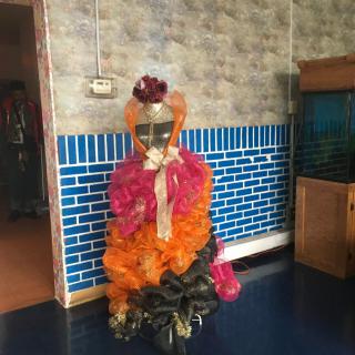 A vibrant, colorful costume on display indoors.