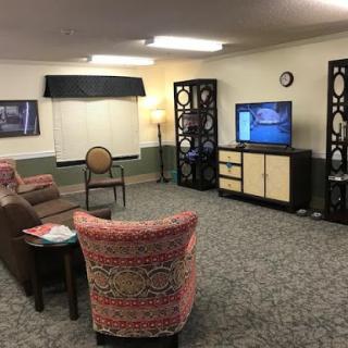 A cozy living room setup featuring comfortable seating and a television.