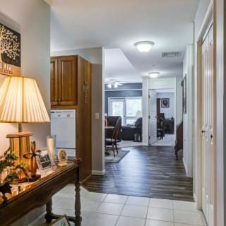 A cozy hallway leading to a living room with warm lighting and stylish decor.