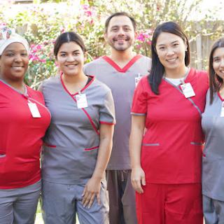 A group of healthcare professionals posing together in their scrubs, showcasing teamwork and camaraderie.
